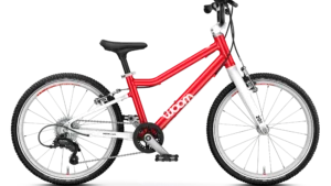 The Woom Go! 4 hot pink 20" is a superlight, versatile children's bike with 20″ wheels, a safety-conscious design, BMX-style bars, and seven easy-to-operate gears for kids aged 6 and up.